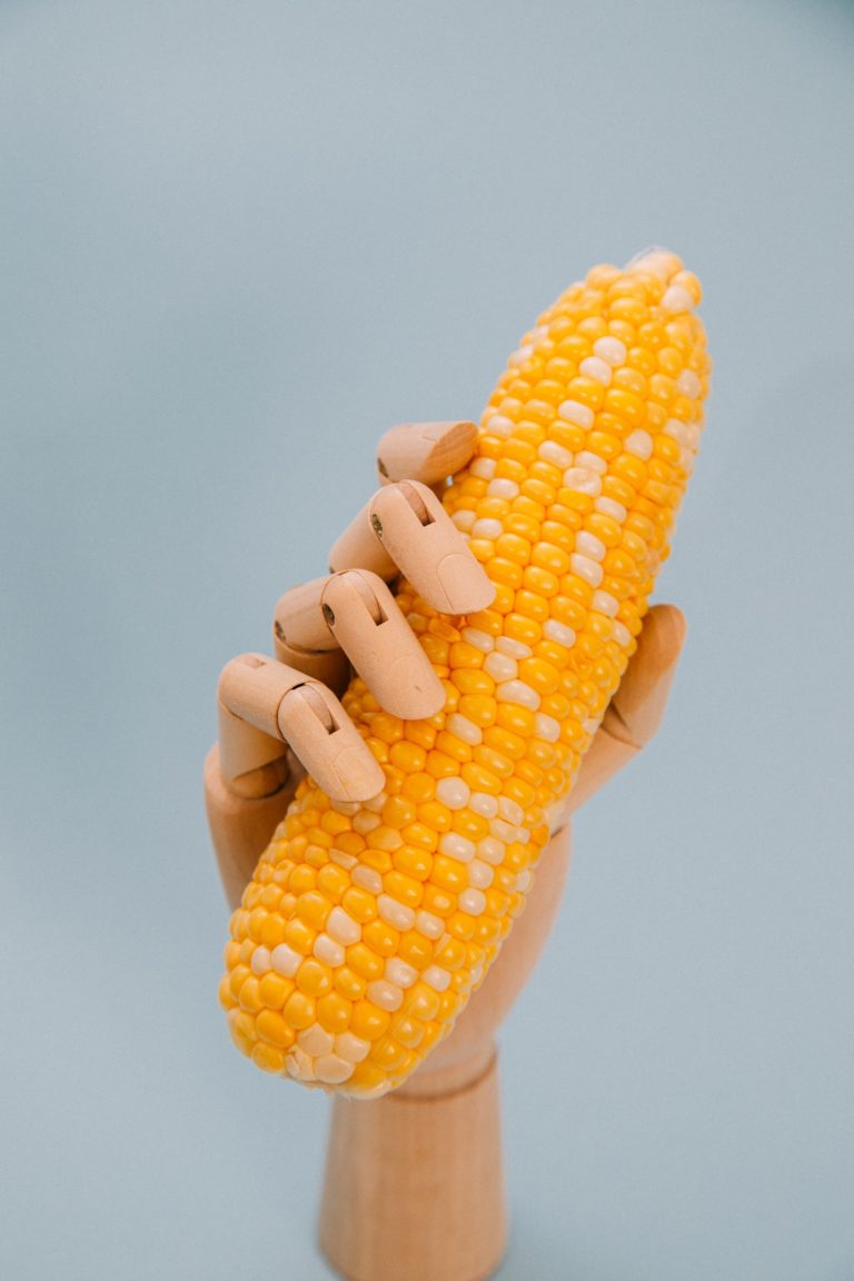 a hand holding a peeled banana