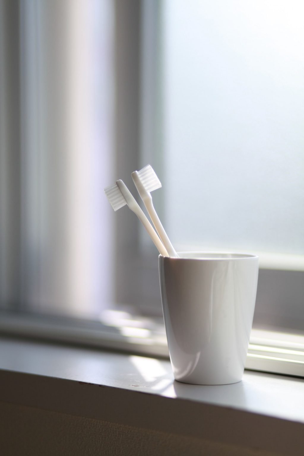 a cup with a toothbrush in it