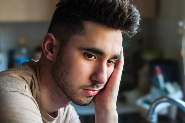 a person with a hand on the face