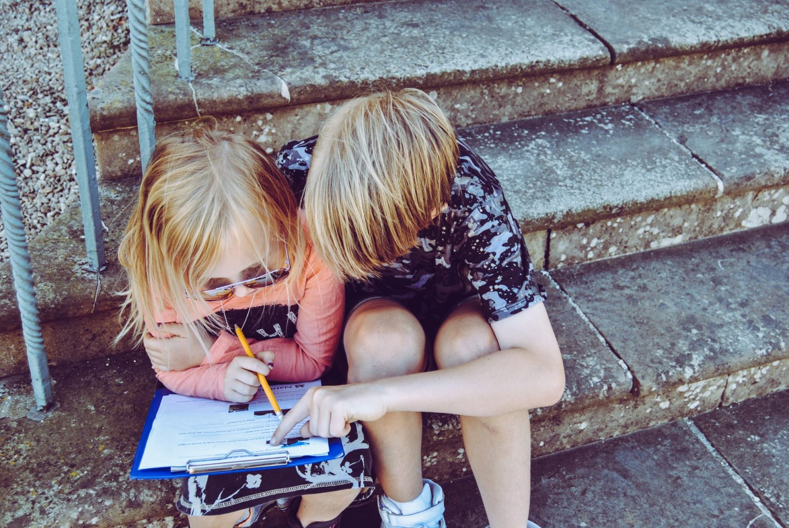 a young girl writing on a piece of paper