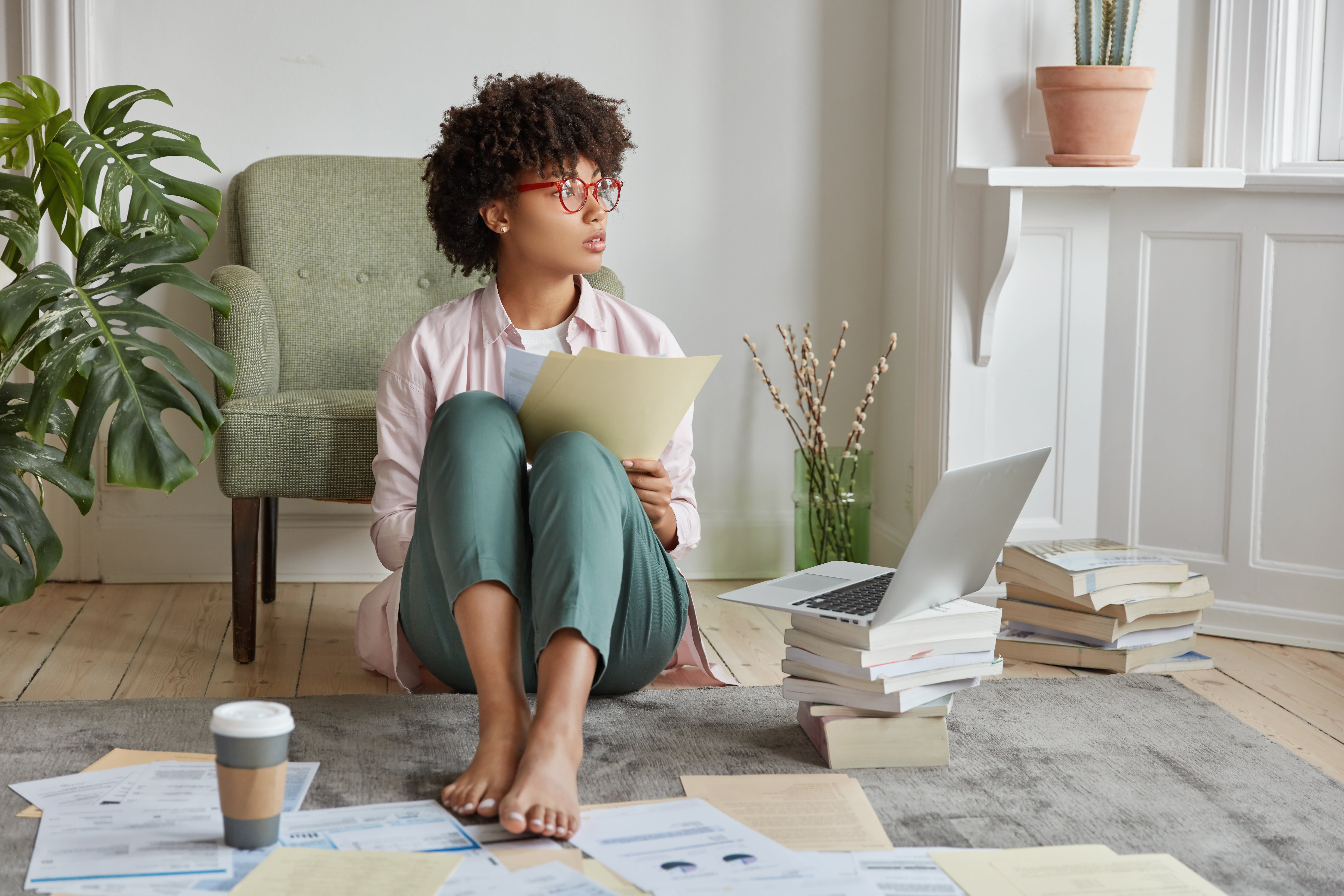 a person sitting on the floor reading a book