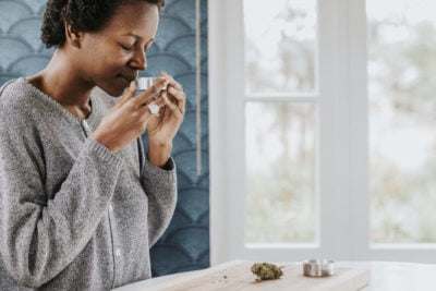 woman smelling a weed